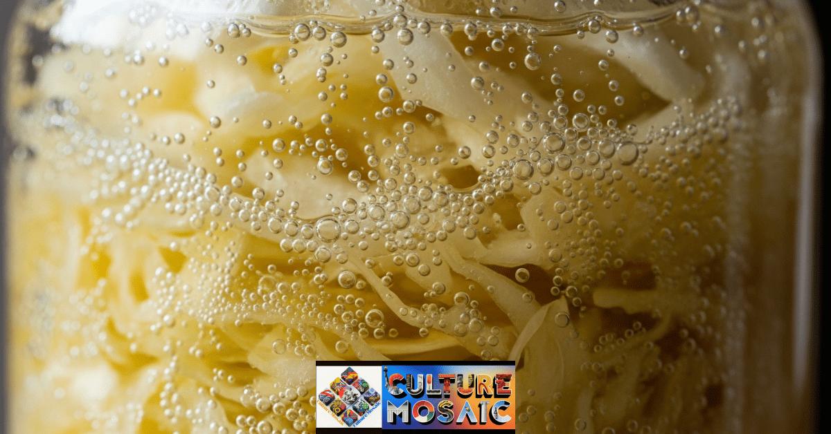 Close-up of active fermentation bubbles in a jar of sauerkraut.