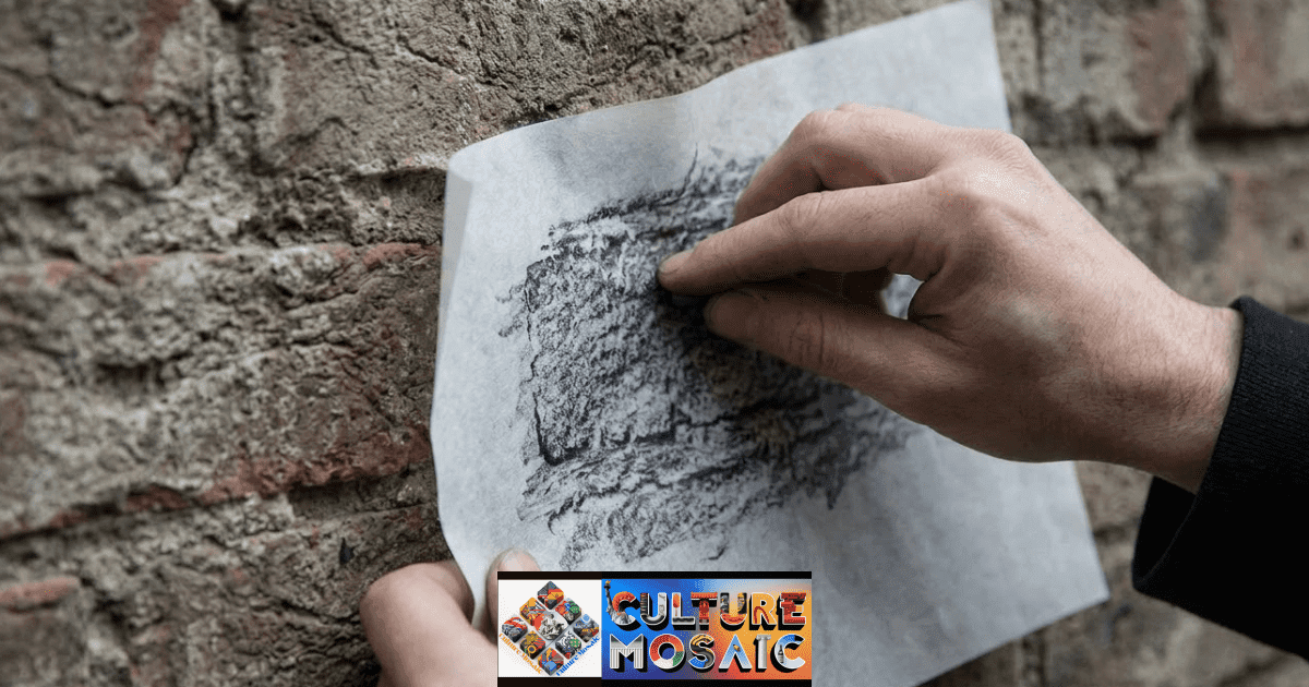 Somatic Art Documentation. A close-up view capturing the precise moment a practitioner’s hand uses a graphite stick to perform frottage on a rough, weathered brick wall, making a direct transfer of the surface texture.