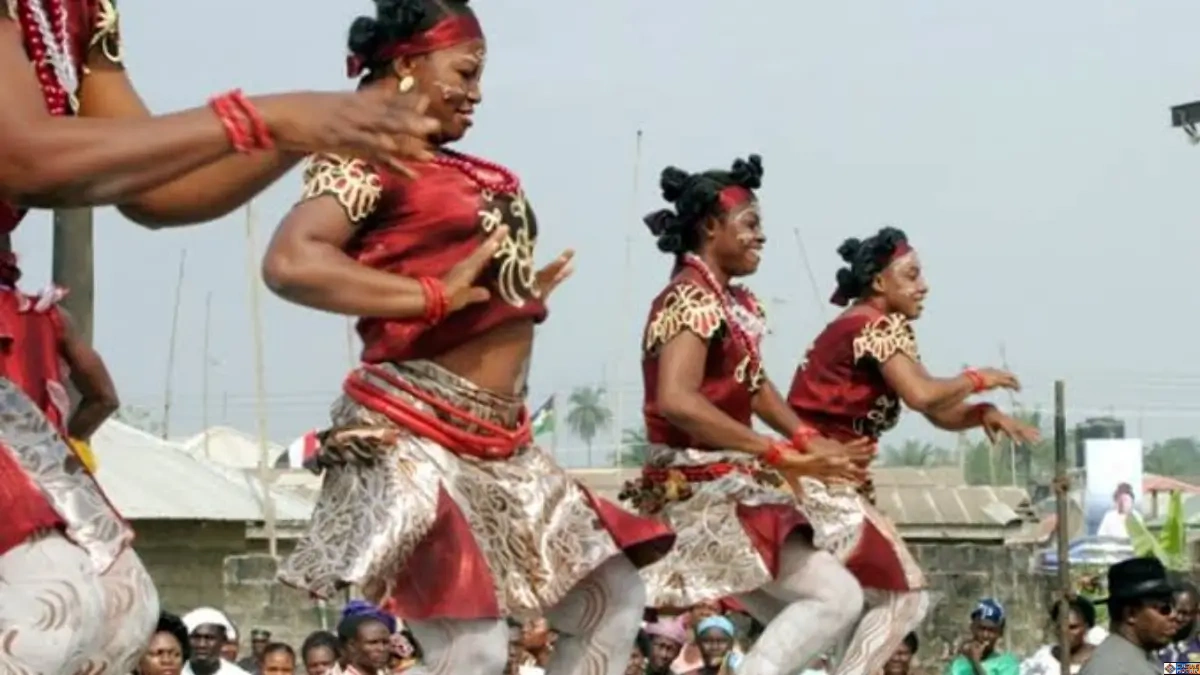 Dancers performing traditional rhythmic movements in a communal ritual, demonstrating somatic heritage practices that heal body memory and regulate the nervous system.