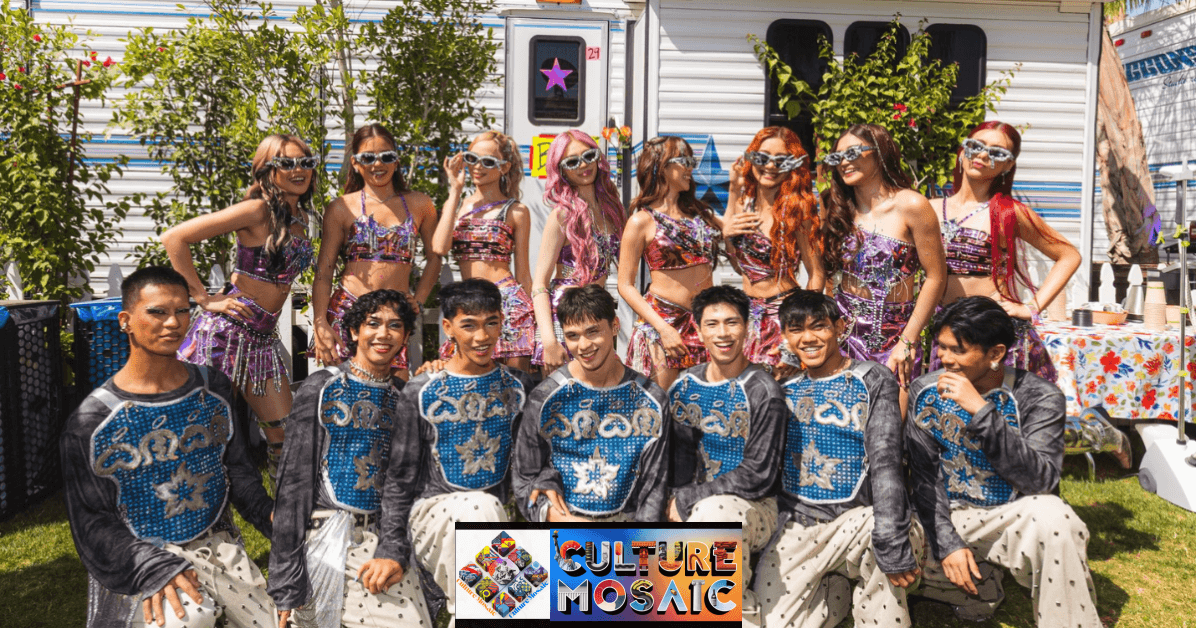 BINI members and their all-male backup dancers pose together outdoors at Coachella 2026 in Indio, California. The BINI members, including Sheena Catacutan BINI, are wearing their Weekend 2 "Signals" outfits—metallic pink and rose gold two-piece ensembles with intricate beadwork and silver futuristic sunglasses. The backup dancers are in gray long-sleeved shirts with blue sequined chest plates and light gray patterned pants. They are positioned in front of white production trailers under bright desert sunlight.