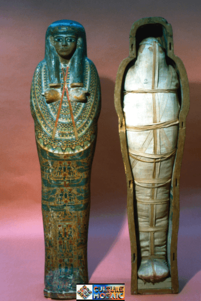 Ancient Egyptian Mummies Preservation Techniques: An ancient Egyptian mummy bound in linen wrappings resting alongside a brightly painted ceremonial sarcophagus case.